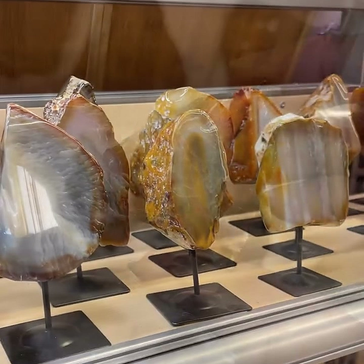 Polished agate slabs on metal stands in the warehouse