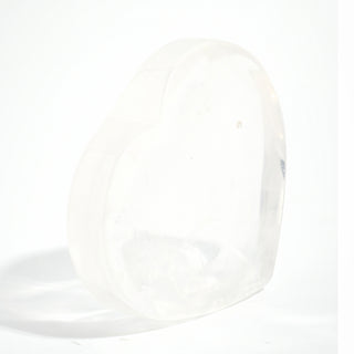 Clear Quartz Heart Bowl standing upright to show the heart outline and the translucency of the clear quartz, on a clean white background. Stonebridge Imports.