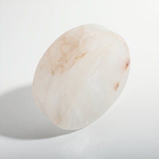 Clear Quartz Round Bowl shown on its side, revealing the disc thickness and reddish quartz veining, photographed on a clean white background. Stonebridge Imports.