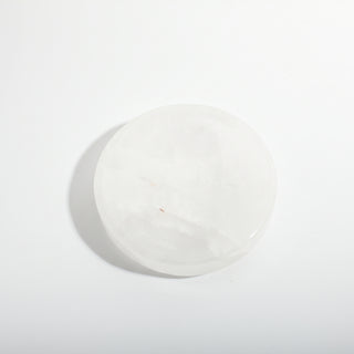 Clear Quartz Round Bowl seen from above, showing the polished shallow carved bowl and soft white translucency, photographed on a clean white background. Stonebridge Imports.