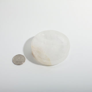 Clear Quartz Round Bowl beside a Canadian dime for scale, about two inches across, milky translucent quartz photographed on a clean white background. Stonebridge Imports.