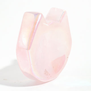 Rose Quartz Aura-Plated Cat Head Bowl standing on edge to show the carved ears and the iridescent aura sheen along the rim, on a clean white background. Stonebridge Imports.