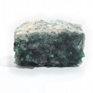 Fluorite Cluster Unique #54, a chunky 7-inch specimen of deep teal-green cubic fluorite crystals under a pale grey-white quartz druzy cap, photographed on a clean white background. Stonebridge Imports.