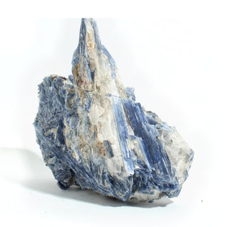 Blue Kyanite Cluster U#116 from the side, layered kyanite blades over quartz with a small natural cavity, on a clean white background. Stonebridge Imports.