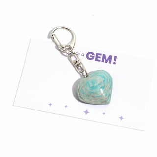 One of the five turquoise amazonite heart charms from the pack, shown on its "you're a GEM!" gift backing card, hanging from its silver clasp on a clean white background. Stonebridge Imports.