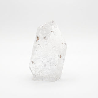Clear Quartz Free Form Unique #1, a polished clear quartz free-form polished point shown from an alternate angle on a clean white background. Stonebridge Imports.