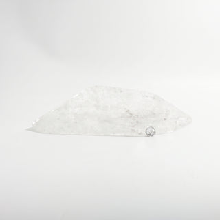 Clear Quartz Free Form Unique #2, a polished clear quartz free-form polished point shown from an alternate angle on a clean white background. Stonebridge Imports.