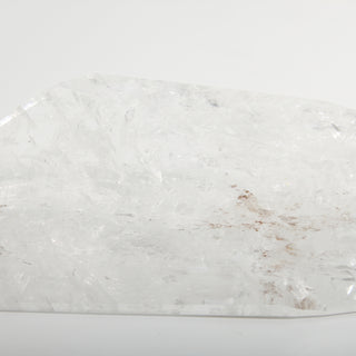 Clear Quartz Free Form Unique #2, a polished clear quartz free-form polished point shown from an alternate angle on a clean white background. Stonebridge Imports.