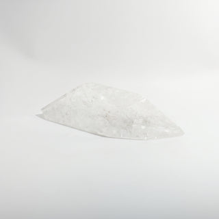 Clear Quartz Free Form Unique #2, a polished clear quartz free-form polished point shown from an alternate angle on a clean white background. Stonebridge Imports.