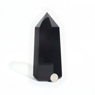 Black Obsidian Generator Unique #6 — polished six-sided tower with a faceted point, beside a Canadian dime for scale, photographed on a clean white background. Stonebridge Imports.