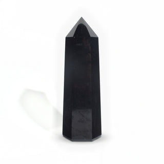 Black Obsidian Generator Unique #11 — polished six-sided tower rising to a faceted point, glossy jet-black faces, photographed on a clean white background. Stonebridge Imports.