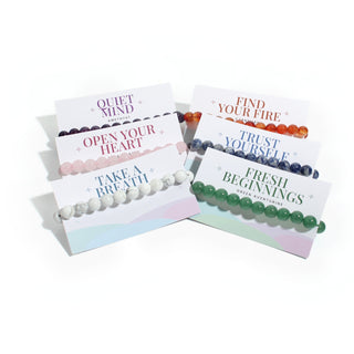 The six intention cards: Quiet Mind amethyst, Open Your Heart rose quartz, Take a Breath howlite, Find Your Fire carnelian, Trust Yourself sodalite, Fresh Beginnings green aventurine, on white. Stonebridge Imports.