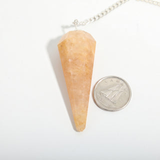 Peach Aventurine Pendulum 6 Facet & Bead - 3 Pack, one peach aventurine pendulum beside a dime for scale, on a clean white background. Stonebridge Imports.