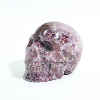 Lepidolite Skull Carving Unique #9, alternate angle photographed on a clean white background. Stonebridge Imports.