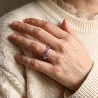 Amethyst Ring worn on the hand in natural light, showing the solid translucent purple amethyst band at true scale.
