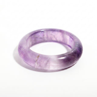 Amethyst Ring — solid translucent purple amethyst stone band ring, alternate angle photographed on a clean white background. Stonebridge Imports.