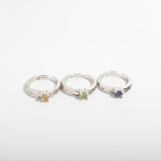 Split Shank Solitaire — Silver Plated Adjustable Rings 3 Pack with assorted natural gemstones in golden, green and violet tones, photographed on a clean white background. Stonebridge Imports.