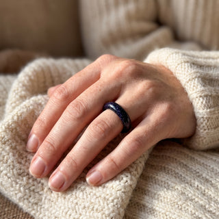 Blue Goldstone Ring (Enhanced) worn on the hand in natural light, showing the solid deep blue goldstone with fine sparkle band at true scale.