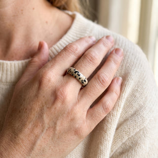 Dalmatian Jasper Ring worn on the hand in natural light, showing the solid cream dalmatian jasper with black spots band at true scale.