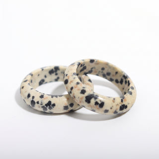 Dalmatian Jasper Ring — solid cream dalmatian jasper with black spots stone band ring, photographed on a clean white background. Stonebridge Imports.