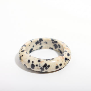 Dalmatian Jasper Ring — solid cream dalmatian jasper with black spots stone band ring, alternate angle photographed on a clean white background. Stonebridge Imports.