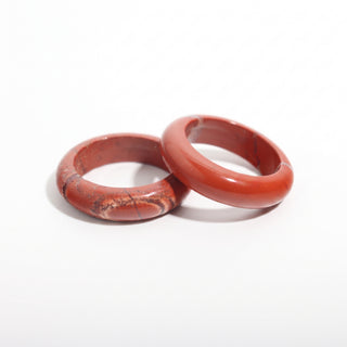 Red Jasper Ring — solid brick-red red jasper stone band ring, photographed on a clean white background. Stonebridge Imports.