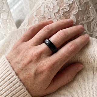 Black Obsidian Ring worn on the hand in natural light, showing the solid glossy black obsidian band at true scale.