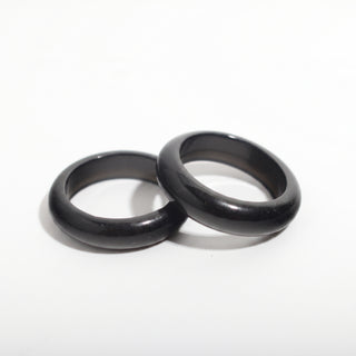 Black Obsidian Ring — solid glossy black obsidian stone band ring, photographed on a clean white background. Stonebridge Imports.