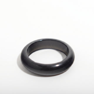 Black Obsidian Ring — solid glossy black obsidian stone band ring, alternate angle photographed on a clean white background. Stonebridge Imports.