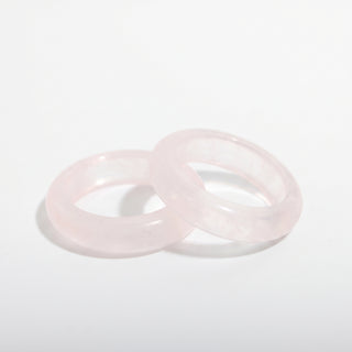 Rose Quartz Ring — solid pale pink rose quartz stone band ring, photographed on a clean white background. Stonebridge Imports.