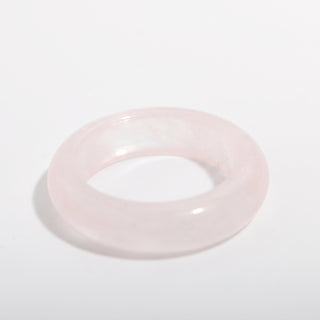 Rose Quartz Ring — solid pale pink rose quartz stone band ring, alternate angle photographed on a clean white background. Stonebridge Imports.