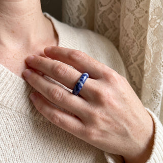 Sodalite Ring worn on the hand in natural light, showing the solid royal-blue sodalite with white veining band at true scale.