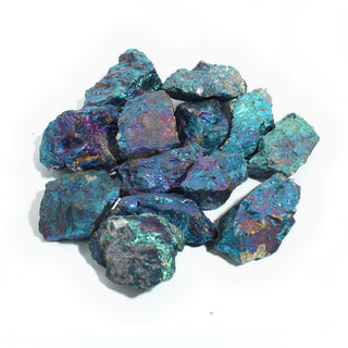 Chalcopyrite E chips, a heap of rough peacock ore pieces flashing iridescent teal, violet and gold, photographed on a clean white background. Stonebridge Imports.