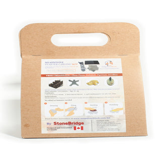 Soapstone Starter Carving Kit in its kraft carry pack with the printed instruction panel facing forward, photographed on a clean white background. Stonebridge Imports.