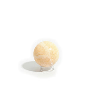 Small #1 - 2 1/4" — Orange Calcite Sphere - Mexico seen from a second side, showing the warm honey mottling through its translucent peach body, photographed on a clean white background. Stonebridge Imports.