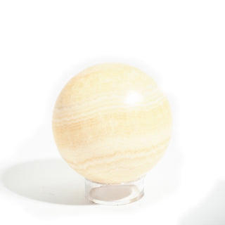 Small #2 - 2 1/4" — Orange Calcite Sphere - Mexico seen from a second side, showing its translucent peach body and pale honey bands, photographed on a clean white background. Stonebridge Imports.