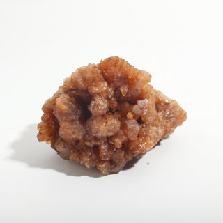 2" — Natural Citrine - Morocco, a chunky honey-brown cluster packed with small glittering crystal points, photographed on a clean white background. Stonebridge Imports.