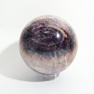 Fluorite Green and Purple Sphere Unique #10, alternate angle showing deep purple and violet banded fluorite with amber-gold seams, on a clean white background. Stonebridge Imports.
