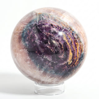 Fluorite Green and Purple Sphere Unique #10, alternate angle showing deep purple and violet banded fluorite with amber-gold seams, on a clean white background. Stonebridge Imports.