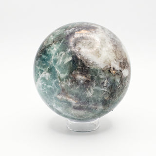 Fluorite Green and Purple Sphere Unique #11, alternate angle showing green and grey fluorite with white feathering and dark inclusions, on a clean white background. Stonebridge Imports.