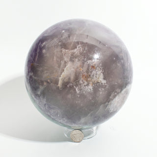 Fluorite Green and Purple Sphere Unique #12, alternate angle showing green and purple fluorite with a golden-brown inclusion, on a clean white background. Stonebridge Imports.