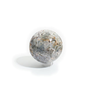 Sea Jasper Sphere Unique #1 seen from a second side, showing more of its rust-orange and olive-green orbicular patterning across a creamy white base, photographed on a clean white background. Stonebridge Imports.