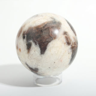 Medium #1 — Chocolate Labradorite Sphere, cream stone with smoky brown-grey labradorite patches, photographed on a clean white background. Stonebridge Imports.