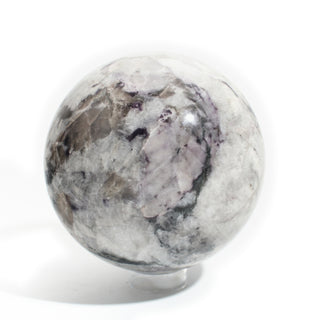 Black Tourmaline and Smoky Quartz Sphere Unique #1, cloudy white and smoky grey quartz patched with black tourmaline, photographed on a clean white background. Stonebridge Imports.