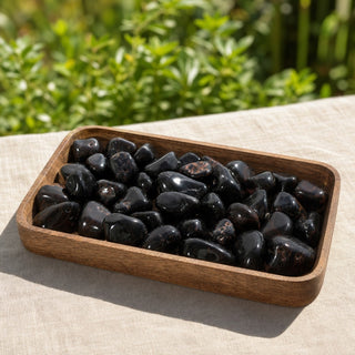 Agate Black Tumbled Stones in a wooden tray at a market stall