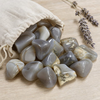 Agate Gray Tumbled Stones spilling from a linen pouch