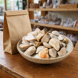 Agatized Coral Tumbled Stones in a ceramic bowl on a shop counter
