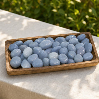 Angelite Tumbled Stones in a wooden tray at a market stall