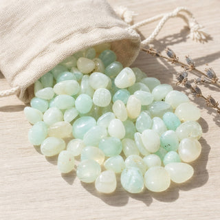 Aqua Onyx Tumbled Stones (Enhanced) spilling from a linen pouch