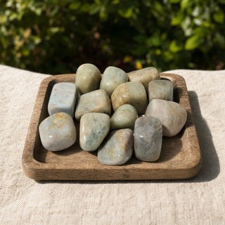 Aquamarine Tumbled Stones - India in a wooden tray at a market stall